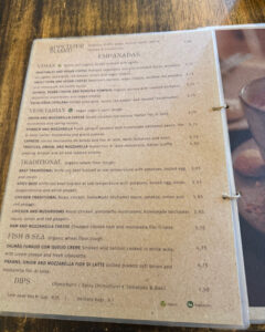 An image of the Empanar menu, showcasing its range of empanadas: vegan, vegetarian, meat, and seafood.